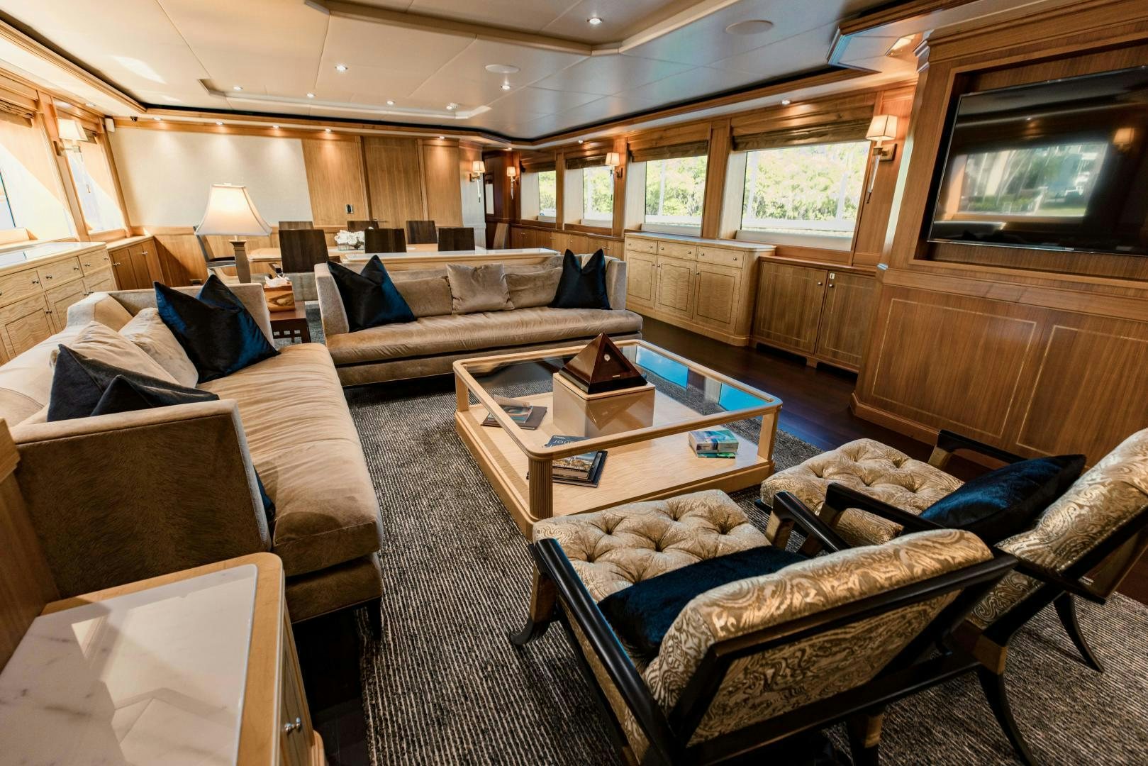 a living room with a couch and a television aboard INVICTUS Yacht for Sale