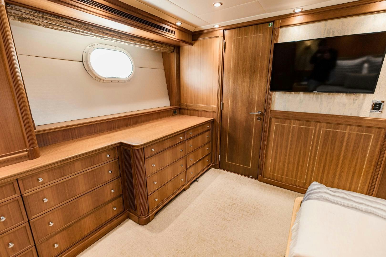 a room with a bed and a television aboard INVICTUS Yacht for Sale