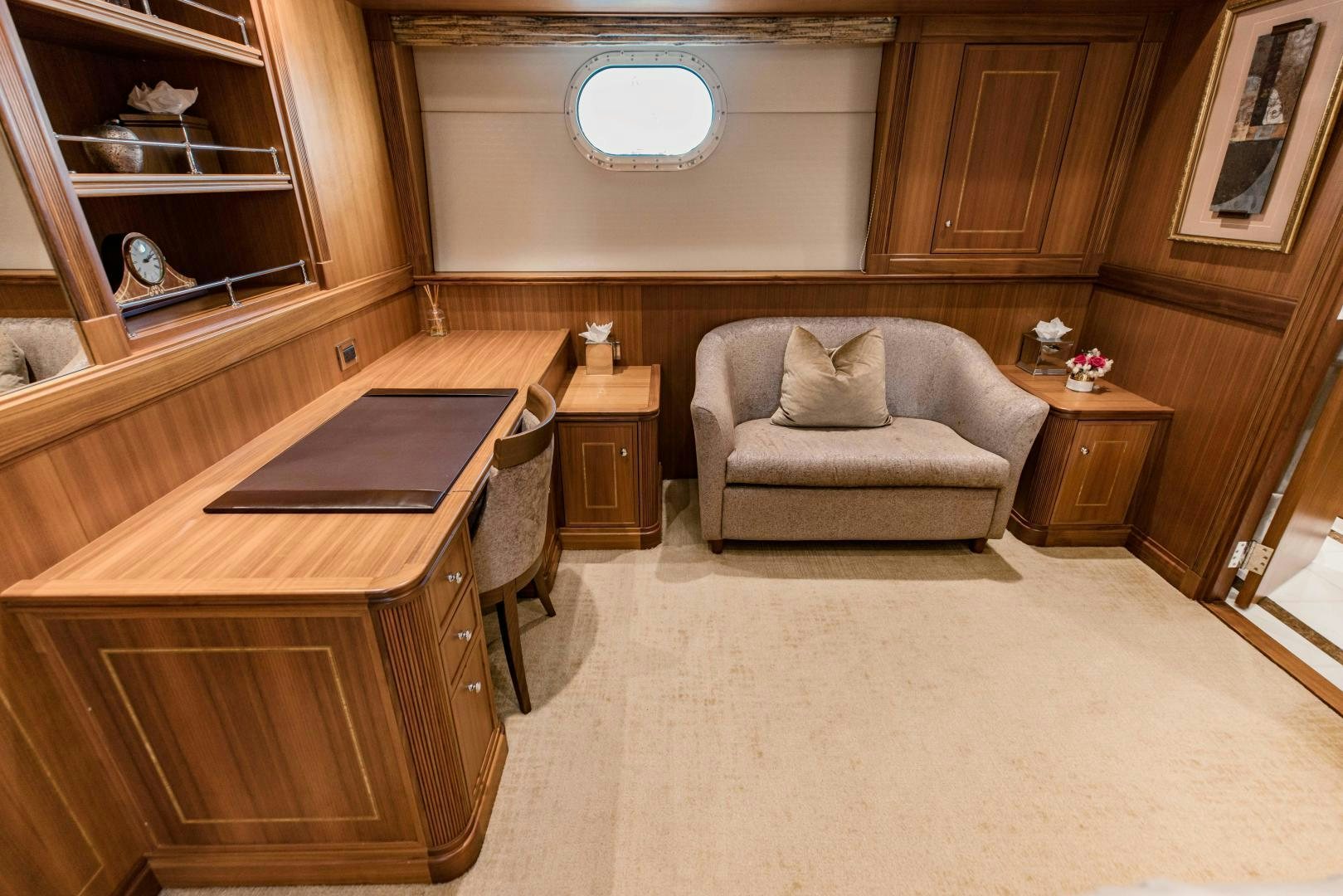 a living room with a couch and a chair aboard INVICTUS Yacht for Sale