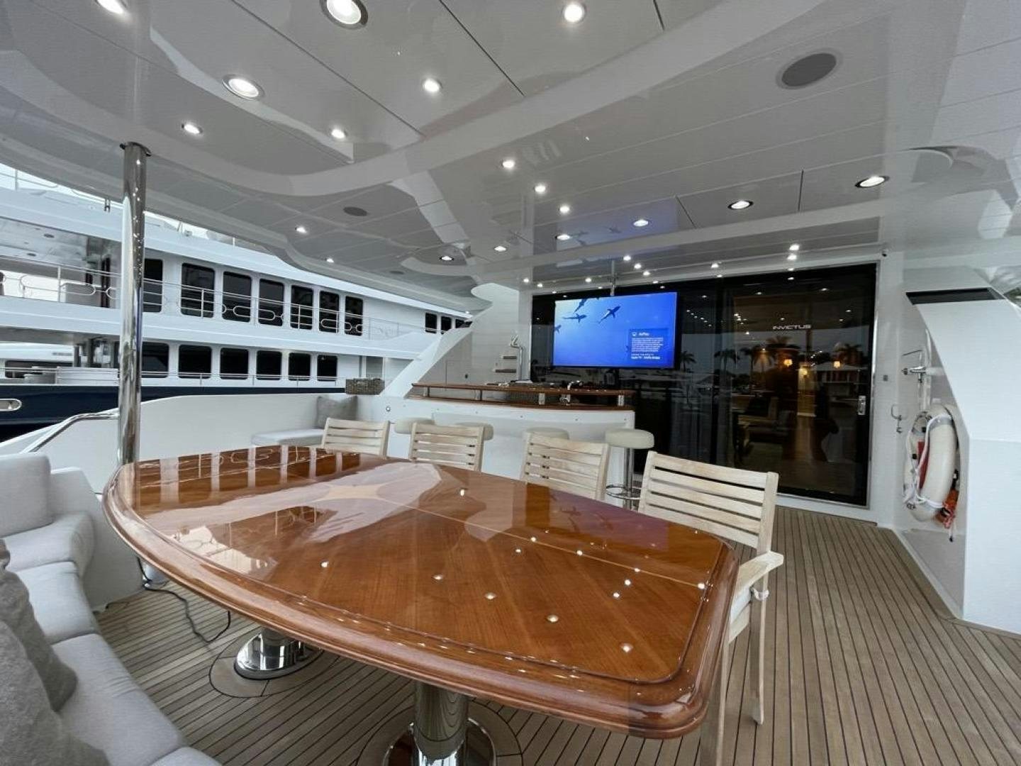 a large room with a table and chairs aboard INVICTUS Yacht for Sale