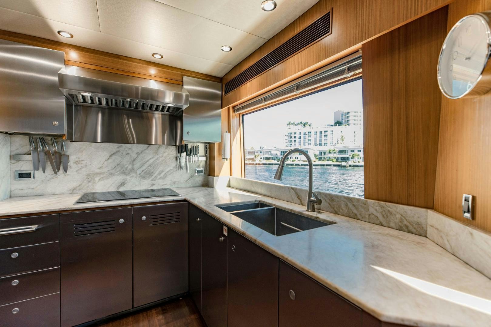 a kitchen with black cabinets aboard INVICTUS Yacht for Sale