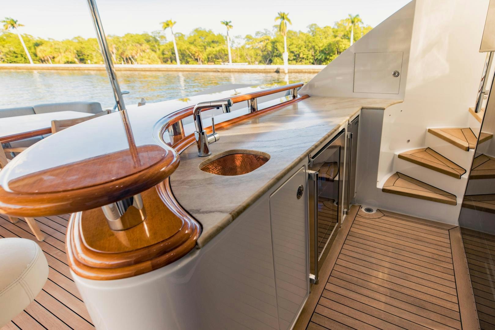 a kitchen with a sink and a wood bar aboard INVICTUS Yacht for Sale