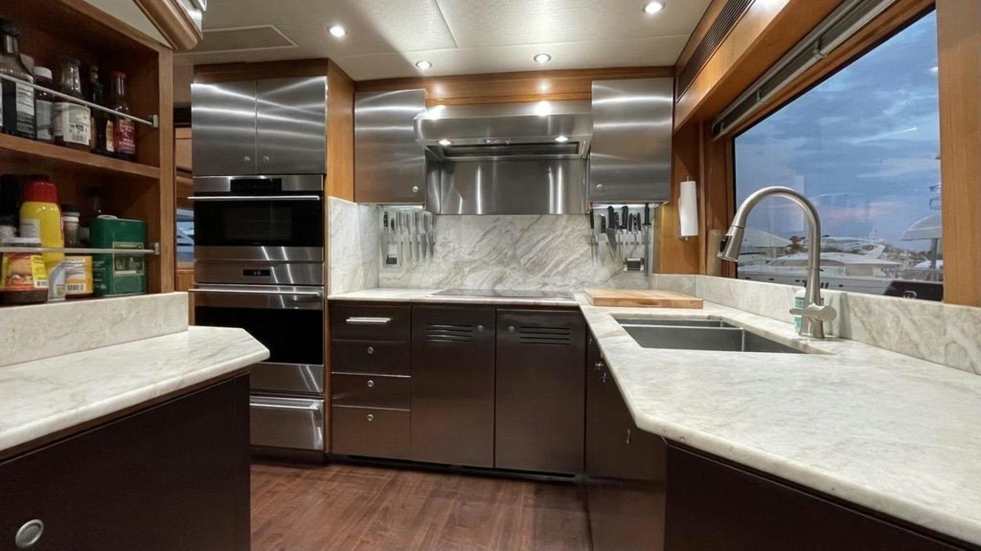 a kitchen with a large window aboard INVICTUS Yacht for Sale