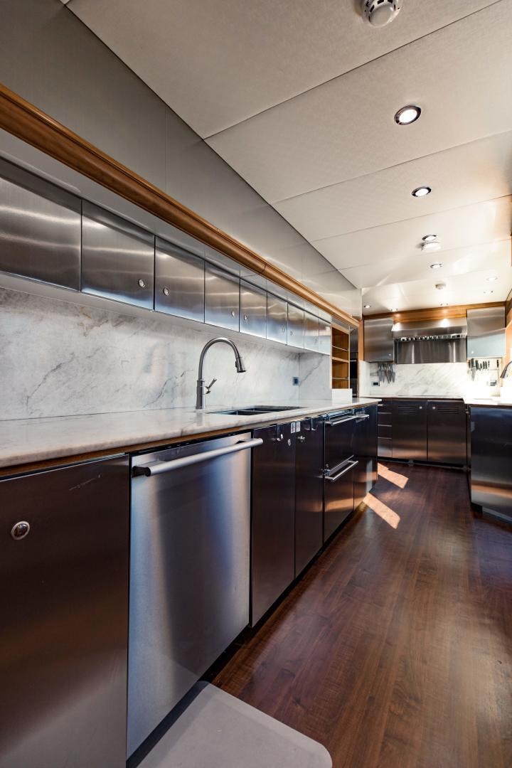 a kitchen with a large stainless steel refrigerator aboard INVICTUS Yacht for Sale
