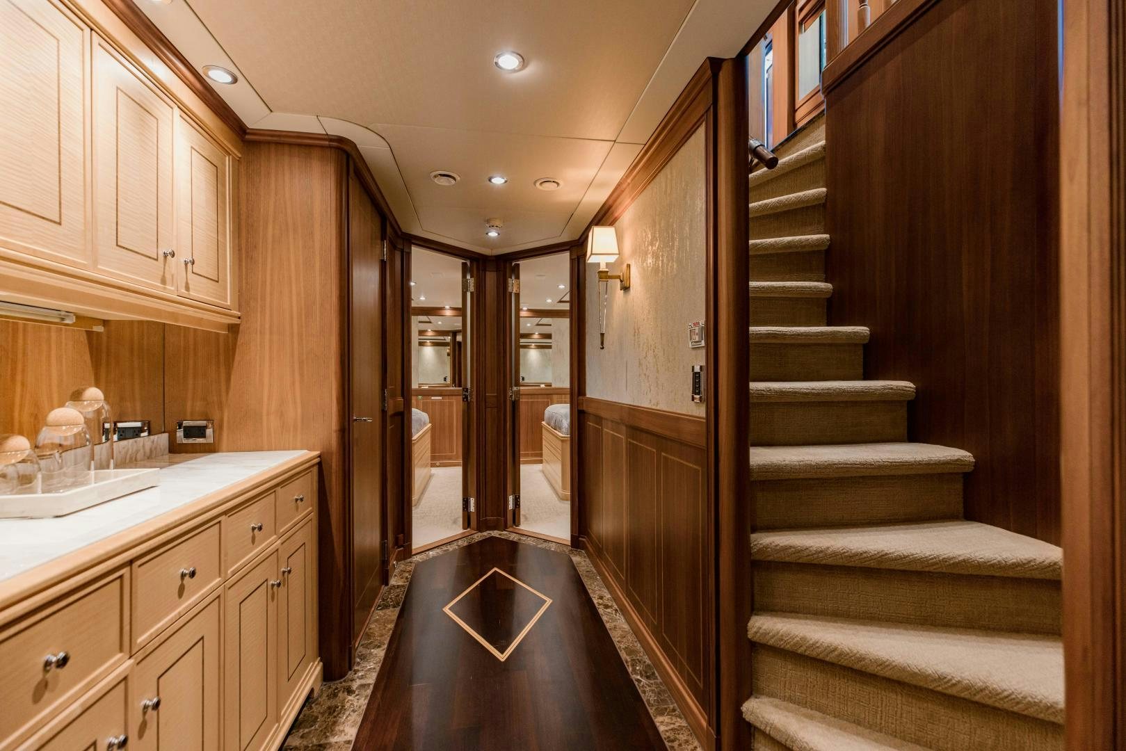 a bathroom with a wood staircase aboard INVICTUS Yacht for Sale