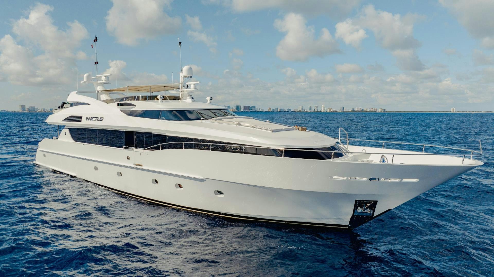 a white yacht in the water aboard INVICTUS Yacht for Sale