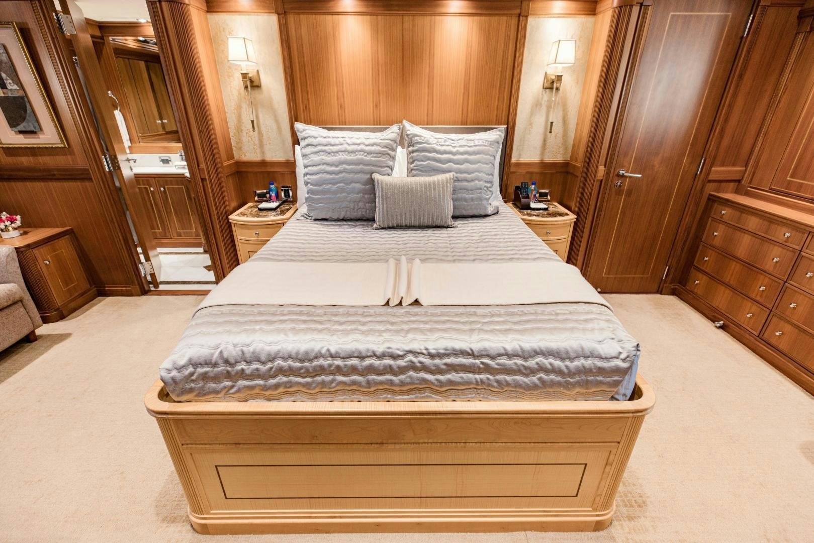 a bed with white sheets aboard INVICTUS Yacht for Sale