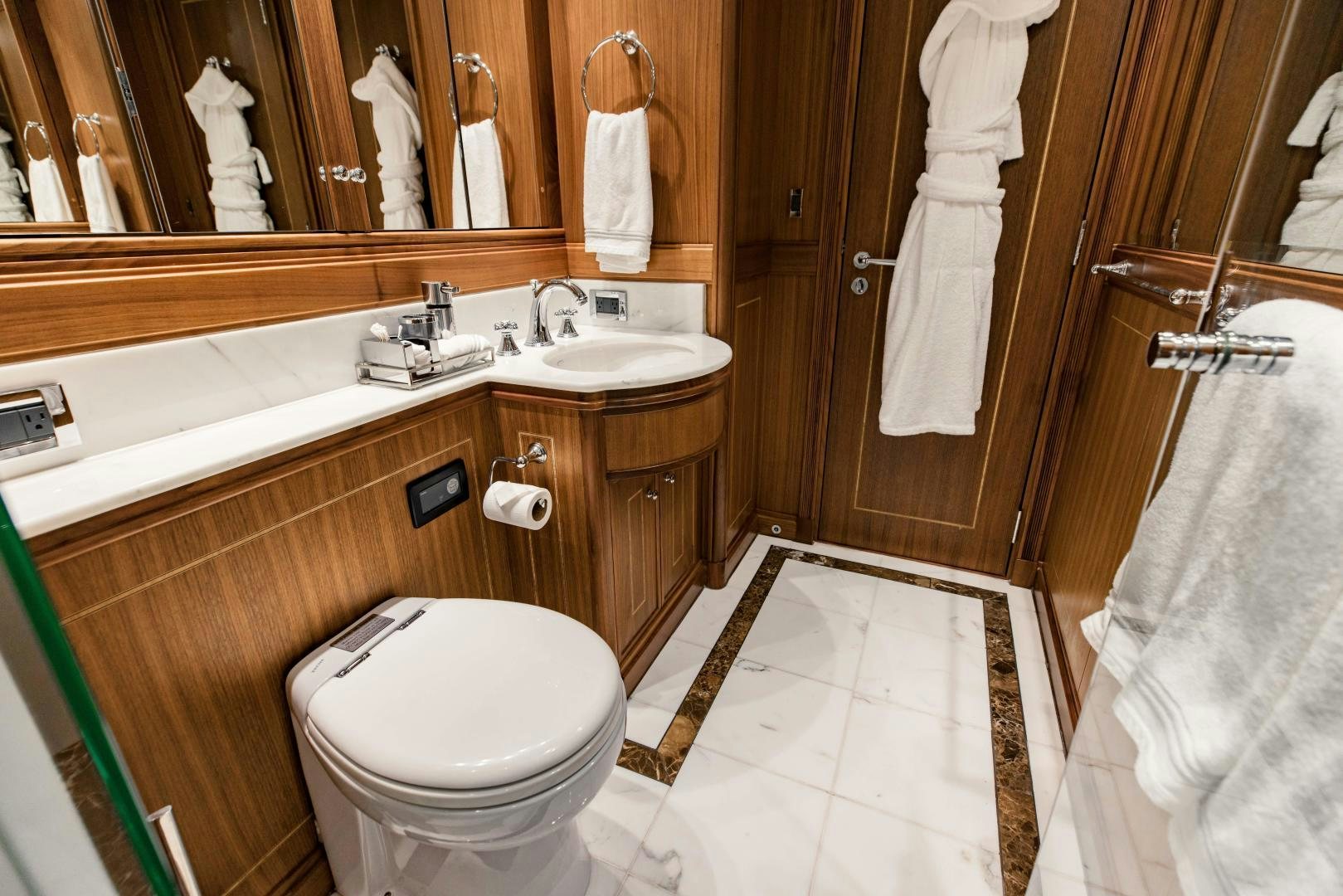 a bathroom with a sink toilet and bathtub aboard INVICTUS Yacht for Sale