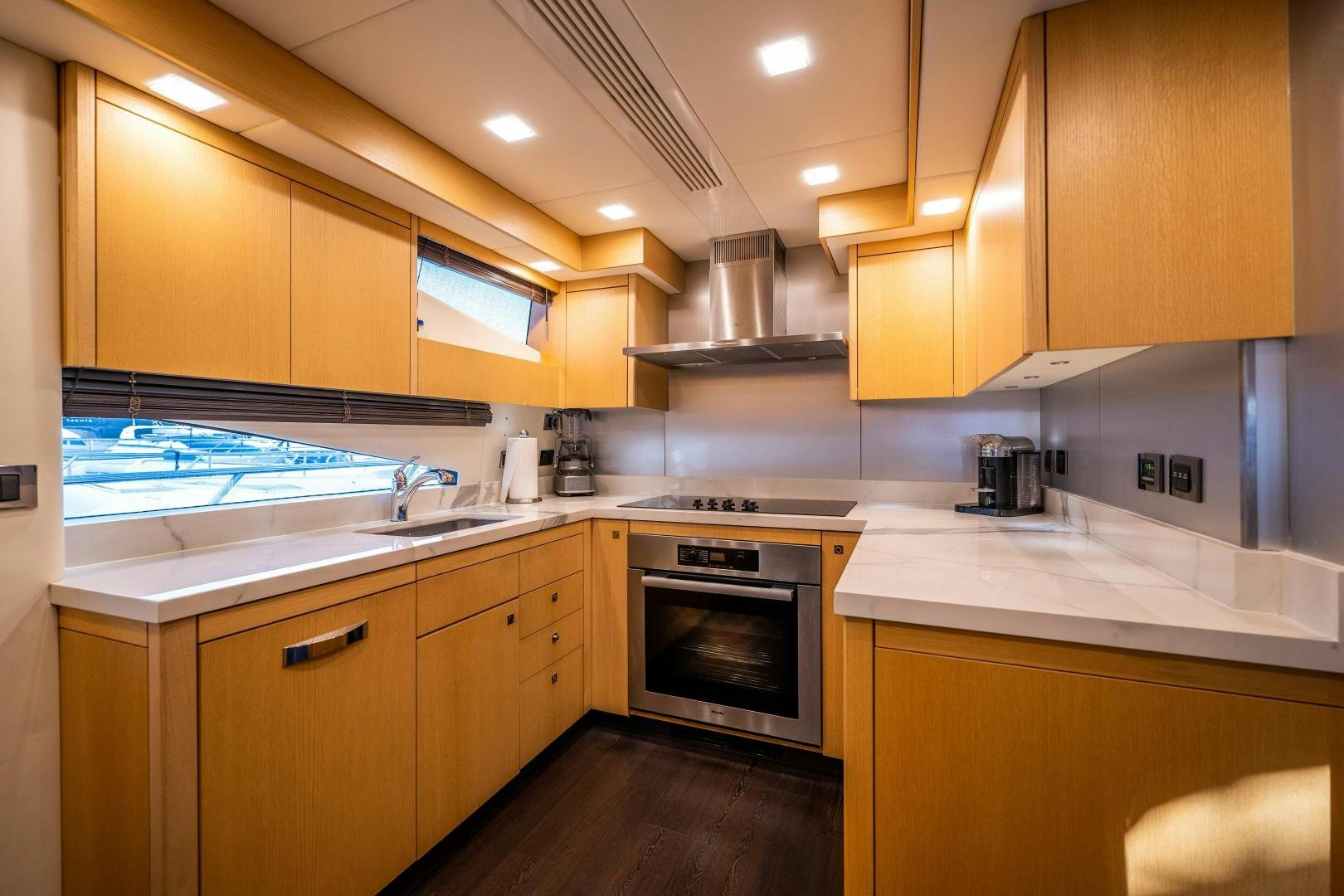 a kitchen with wooden cabinets aboard THE KING Yacht for Sale