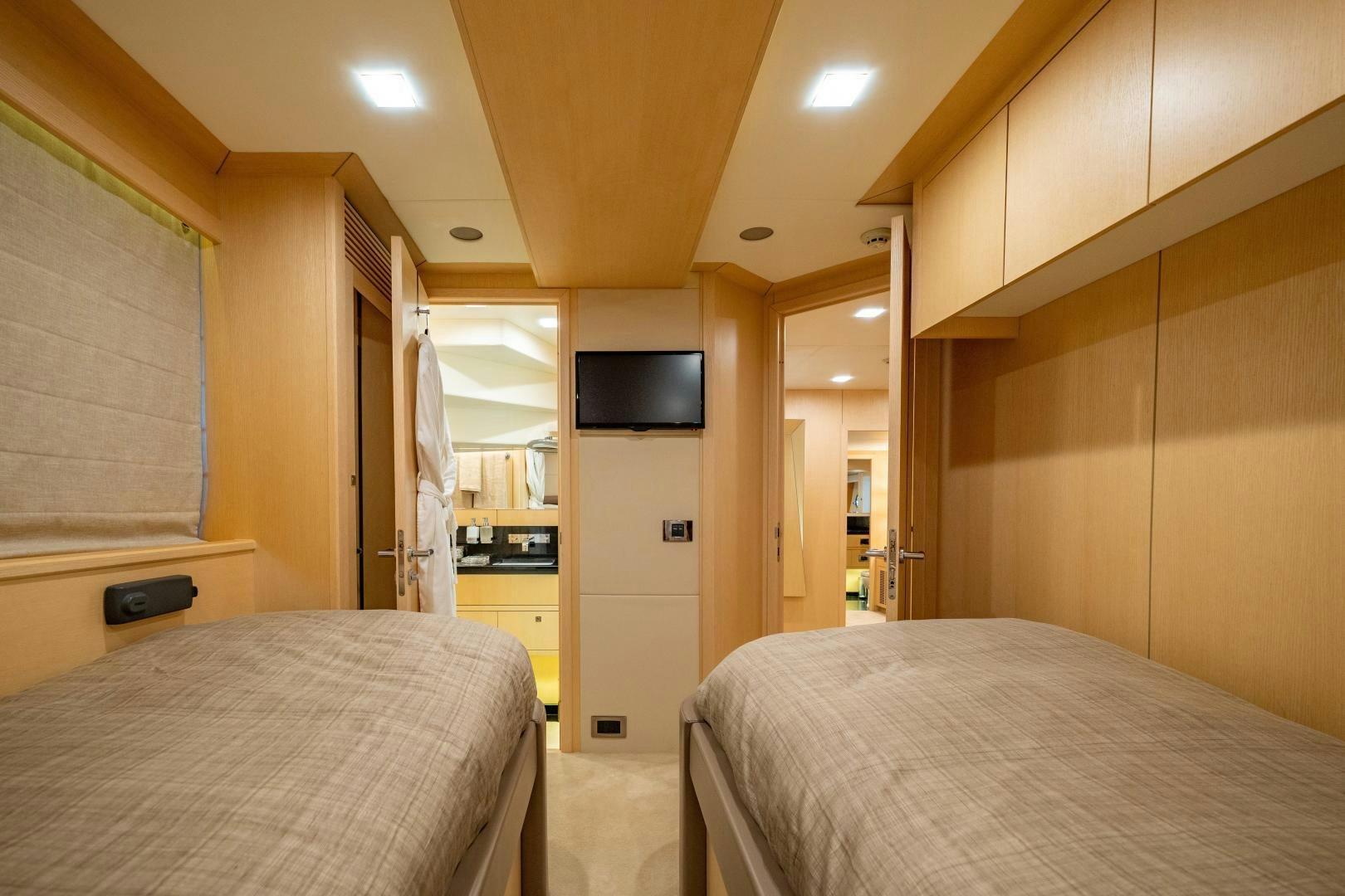 a bedroom with a bed and a television aboard THE KING Yacht for Sale