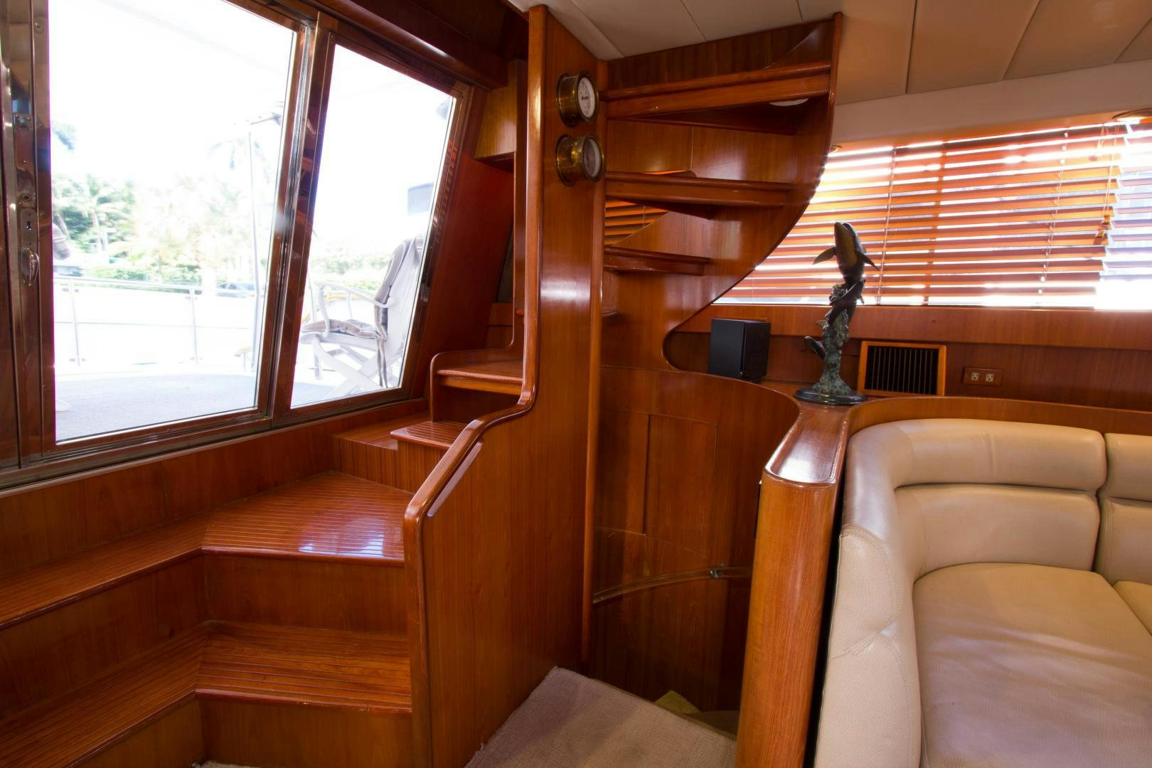 a room with a wood shelf and a chair and a window aboard Seaquest Yacht for Sale