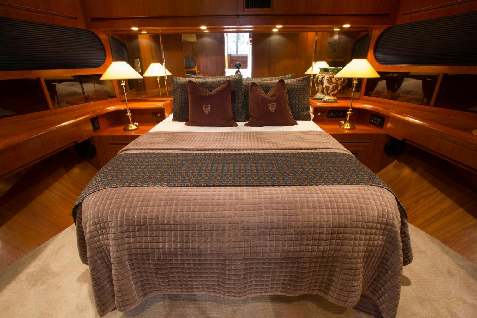 a bed with a black and white comforter and pillows aboard Seaquest Yacht for Sale