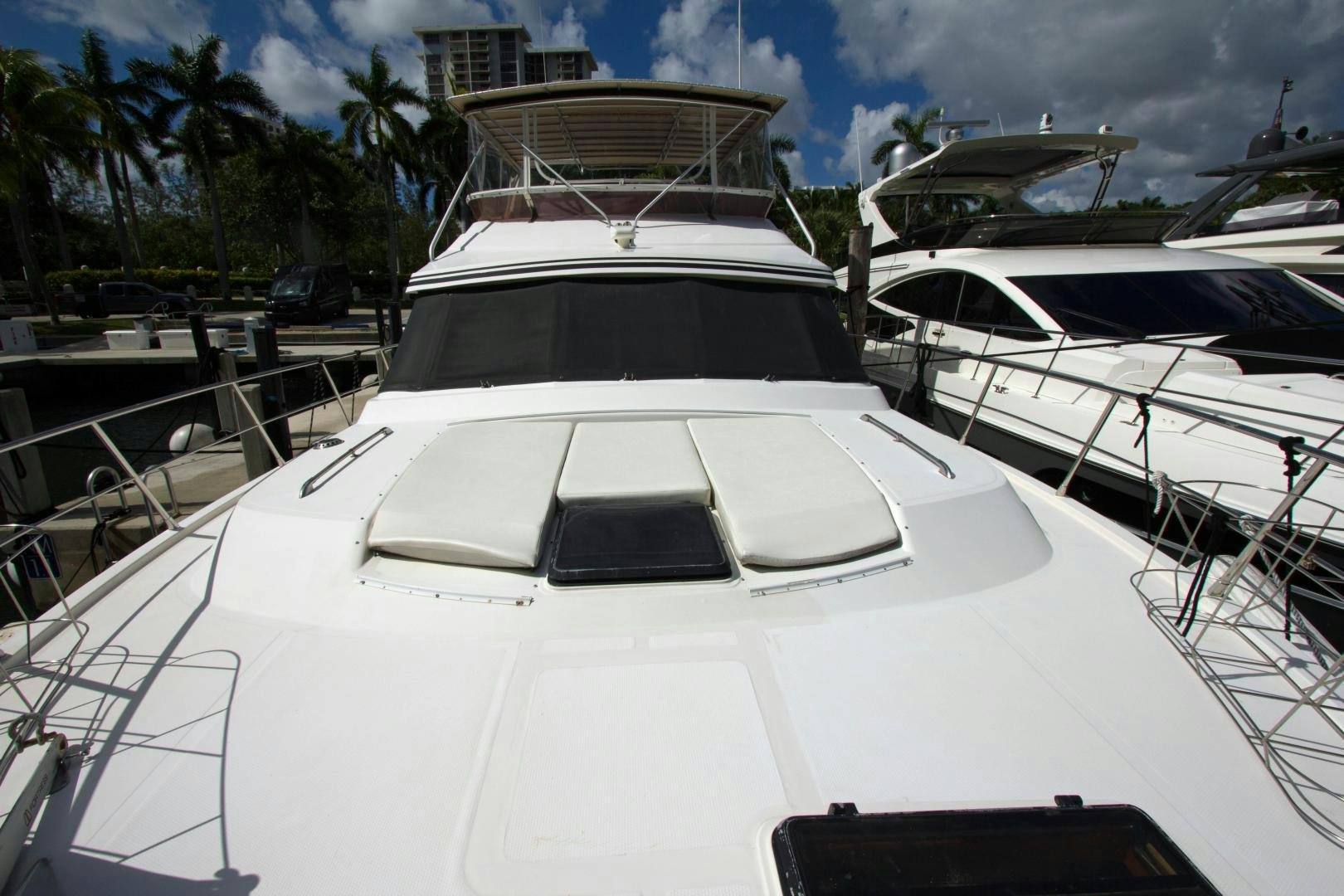 a white yacht on a dock aboard Seaquest Yacht for Sale