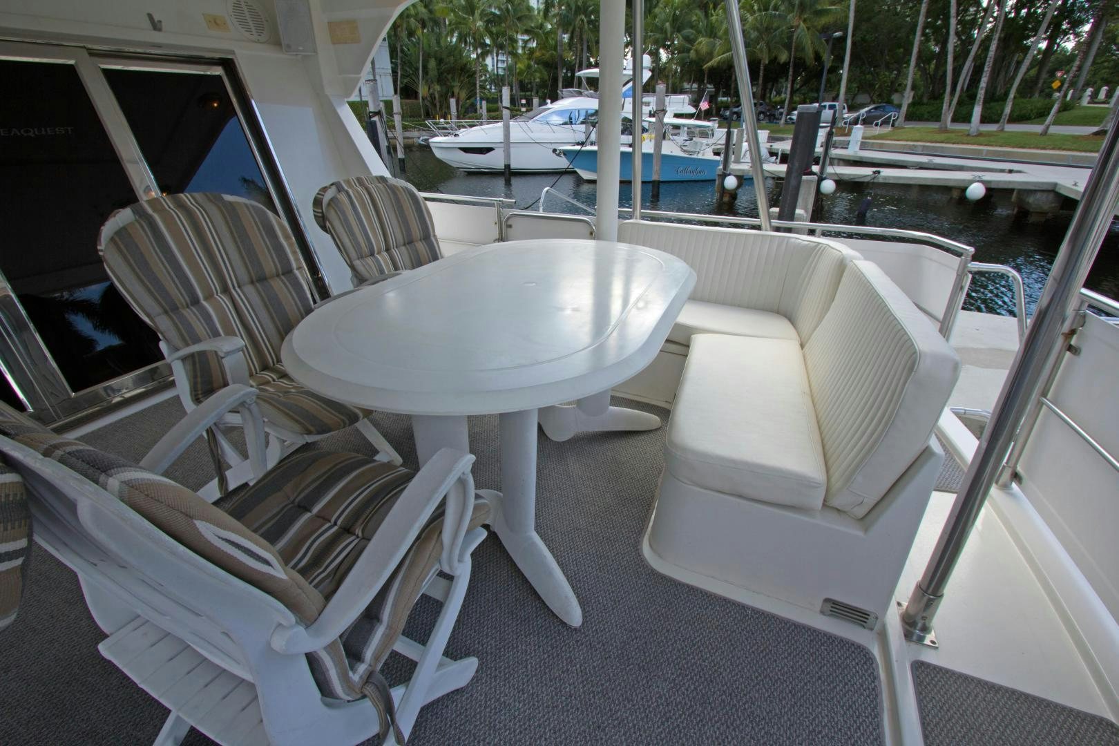a table and chairs outside a pool aboard Seaquest Yacht for Sale