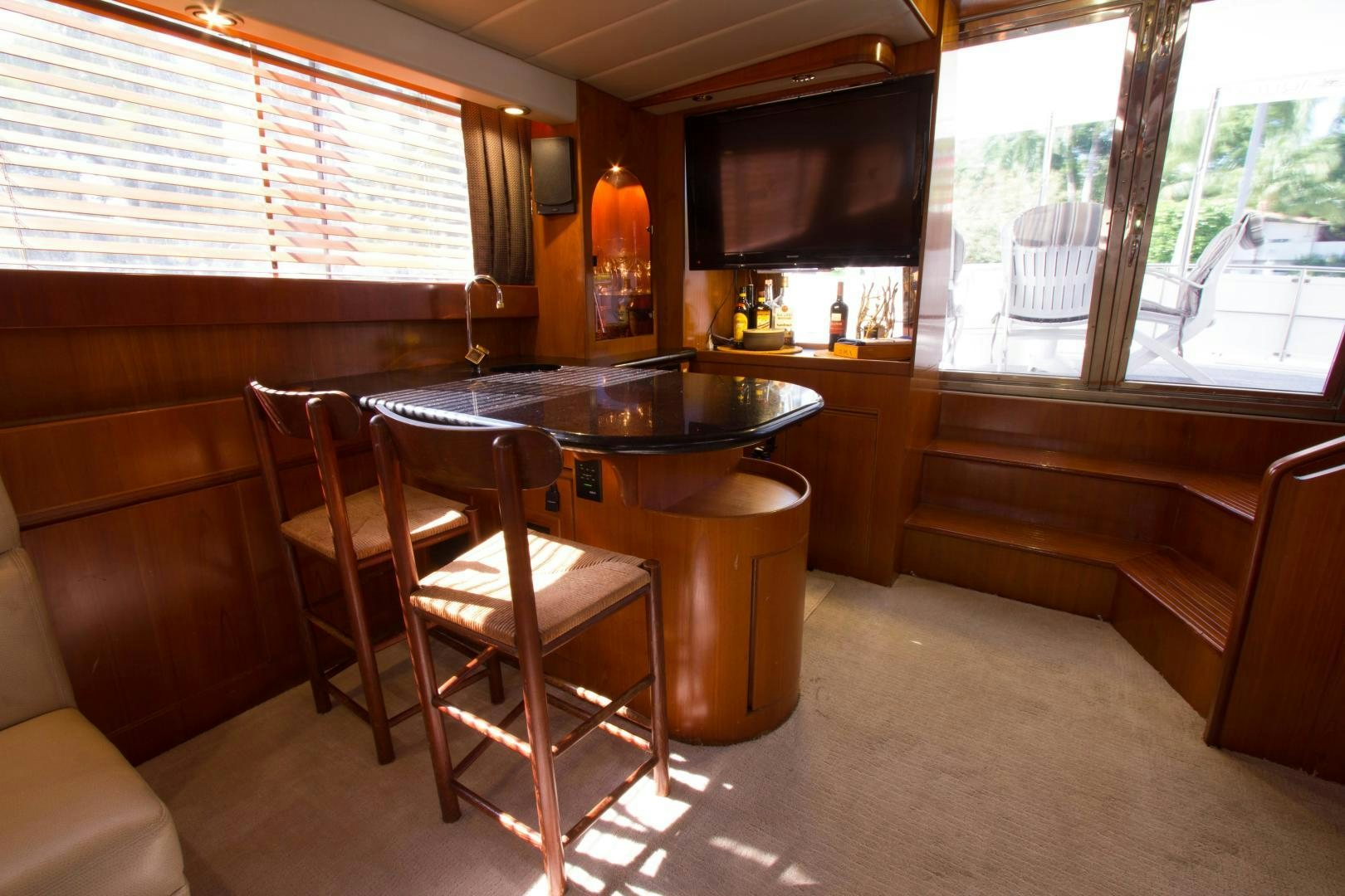 a kitchen with a bar and a table aboard Seaquest Yacht for Sale