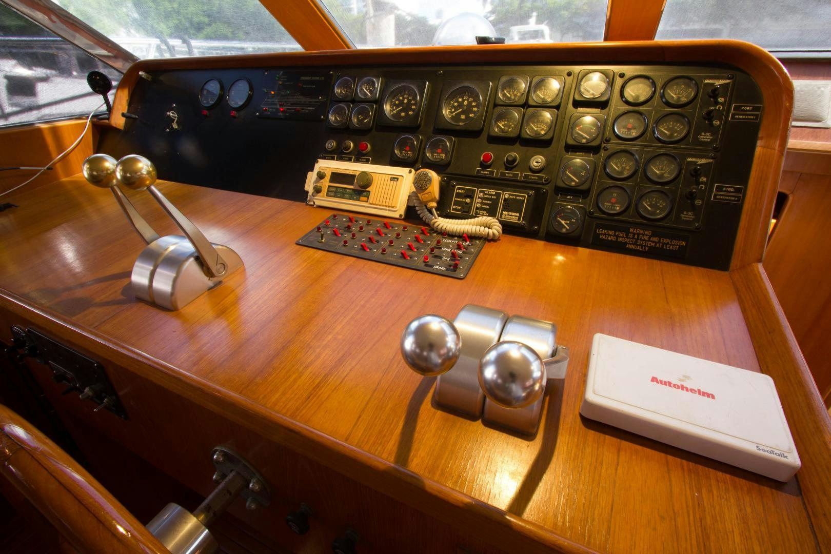 a radio and other electronics on a table aboard Seaquest Yacht for Sale