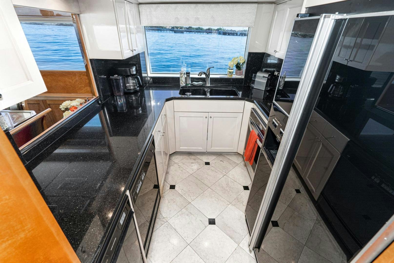 a kitchen with a black counter top aboard LOVELIEST LADY Yacht for Sale