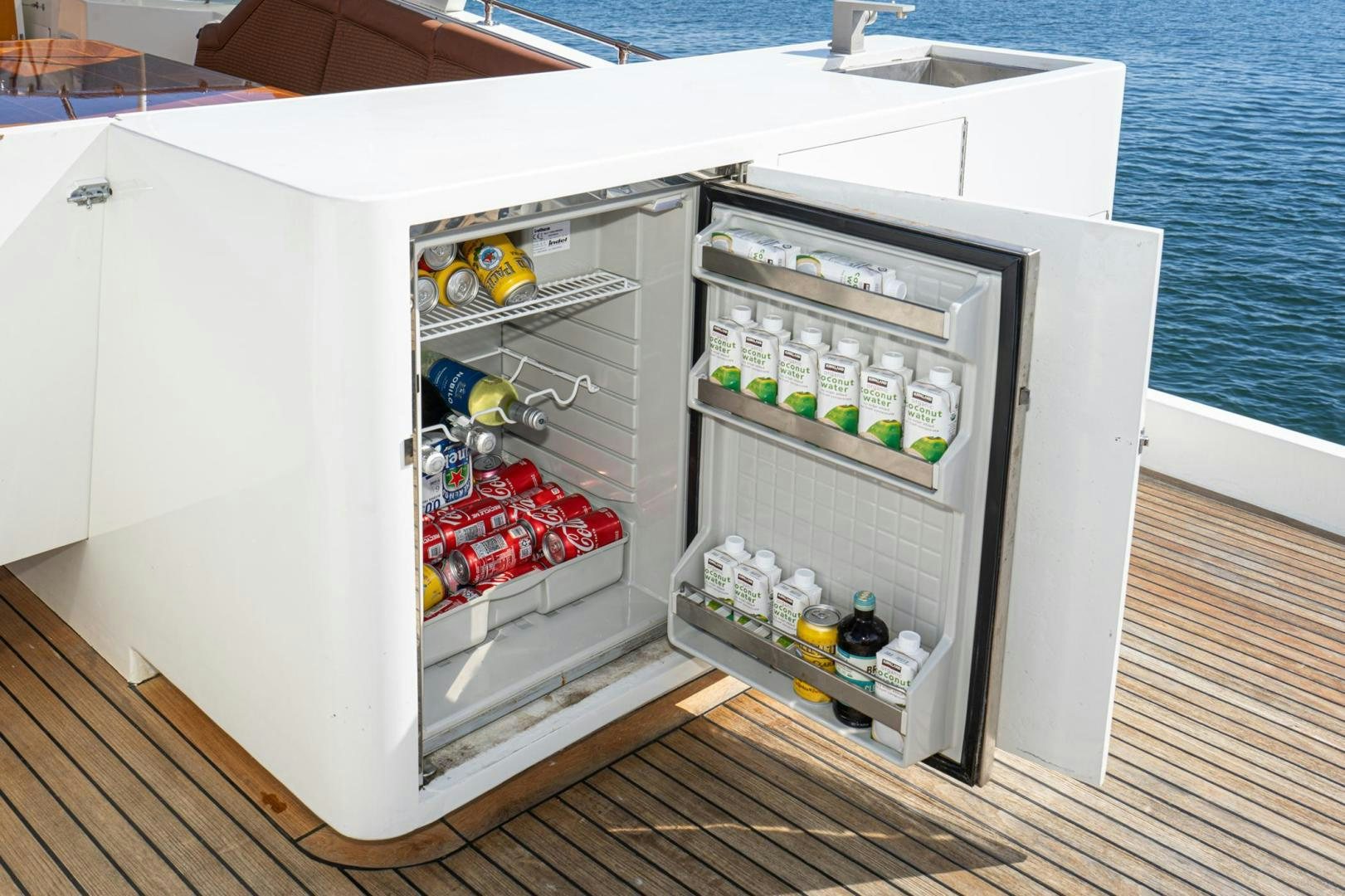 a refrigerator with drinks and bottles aboard LOVELIEST LADY Yacht for Sale