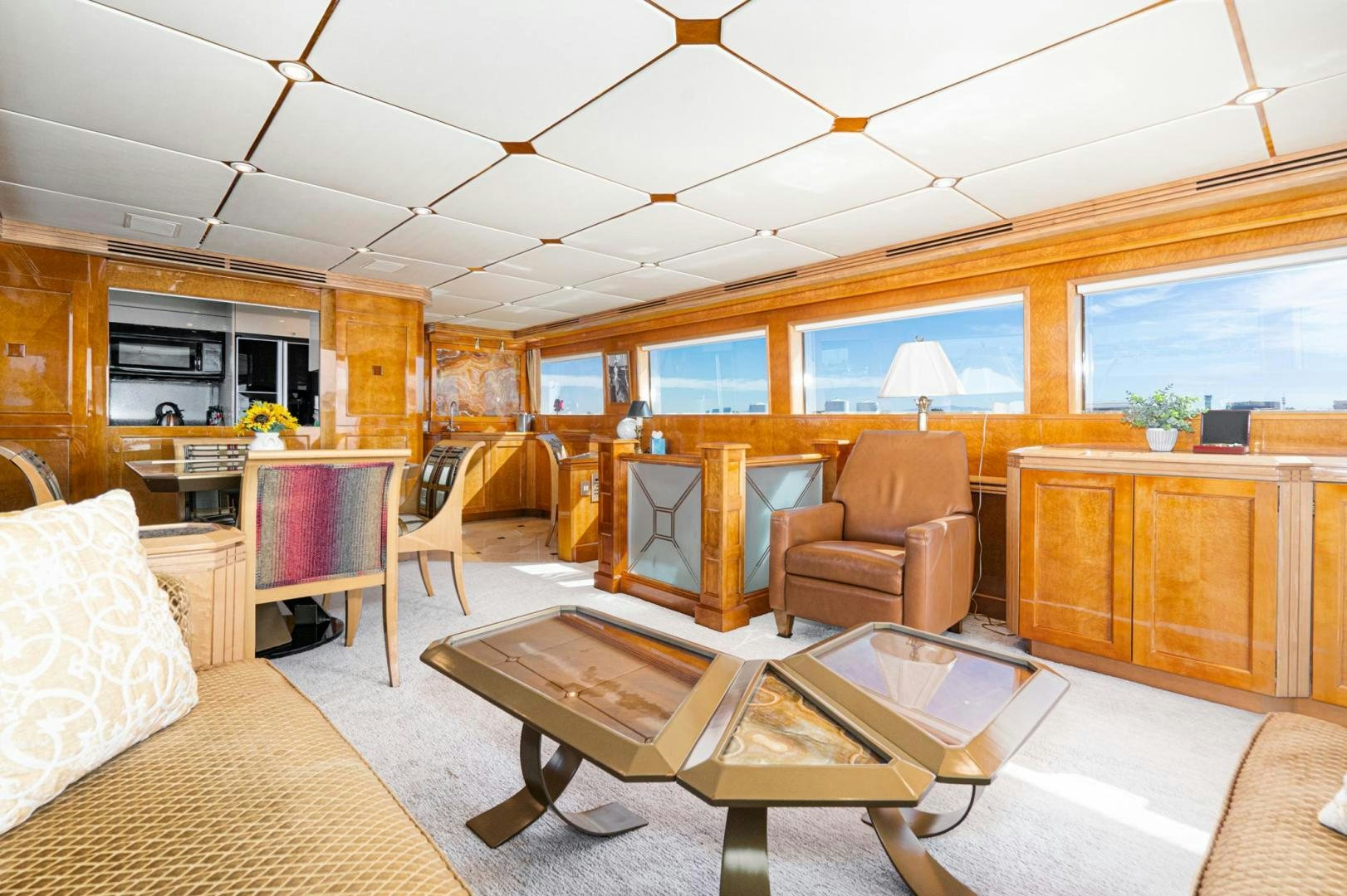 a living room with a table and chairs aboard LOVELIEST LADY Yacht for Sale