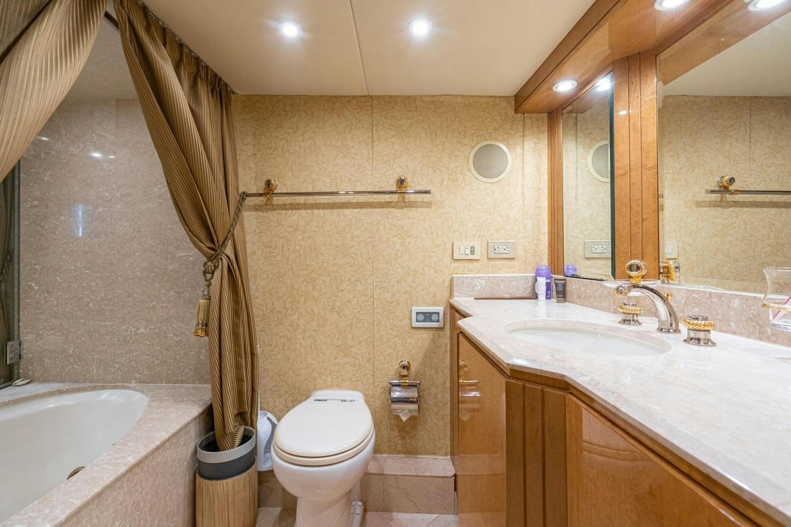 a bathroom with a toilet sink and bathtub aboard LOVELIEST LADY Yacht for Sale