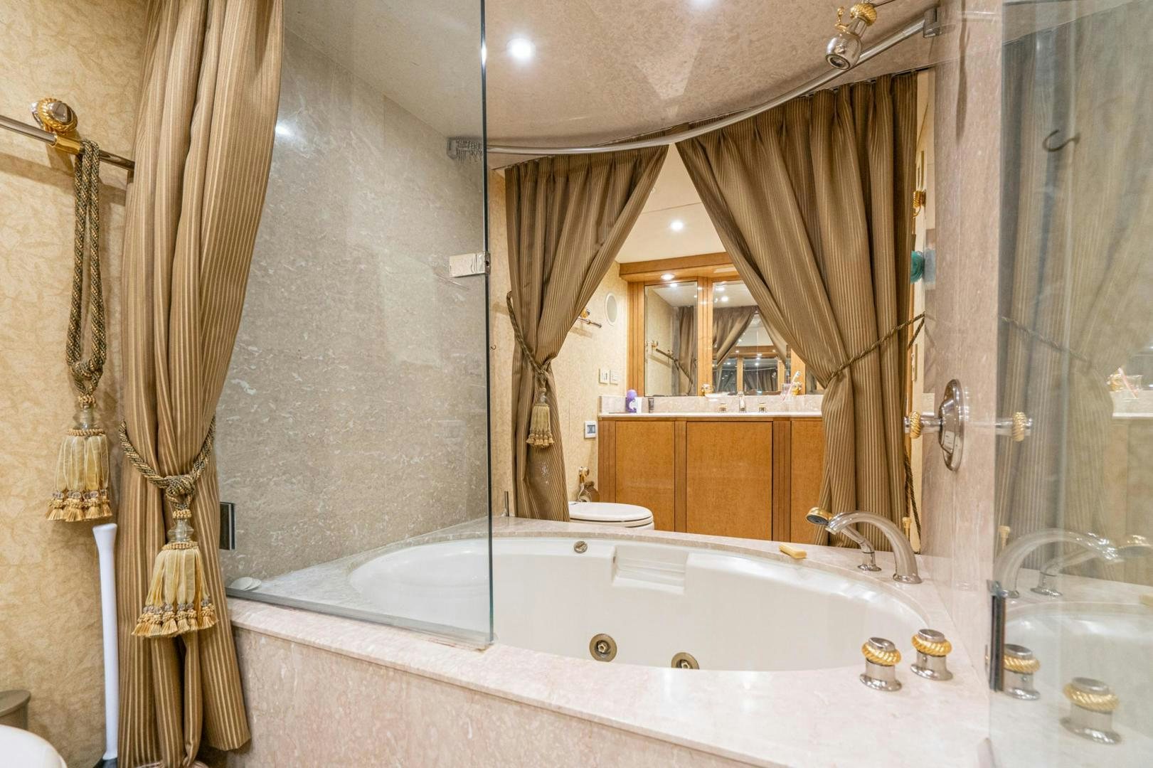 a bathroom with a bathtub and shower aboard LOVELIEST LADY Yacht for Sale