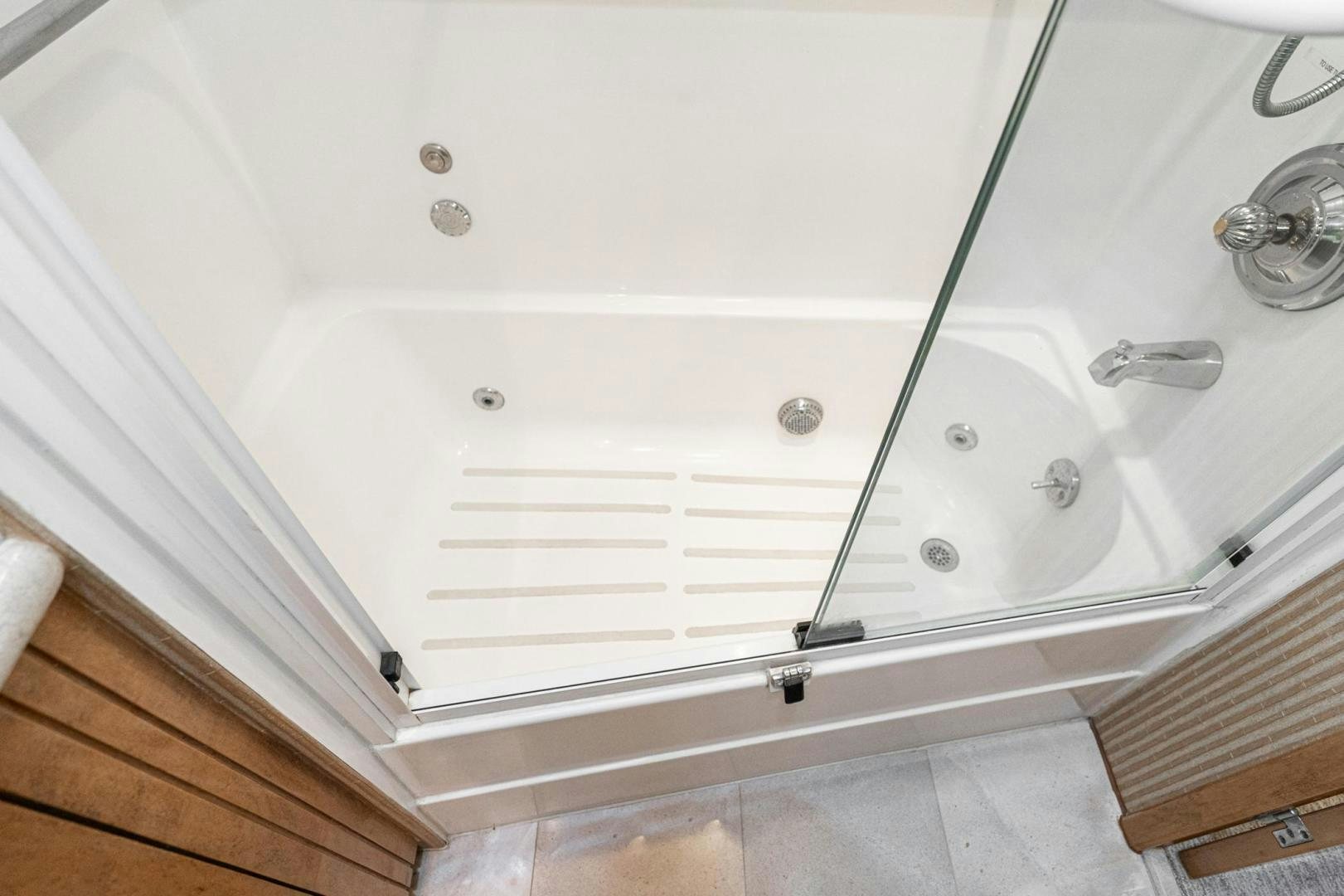 a white bathtub with a glass door aboard LOVELIEST LADY Yacht for Sale