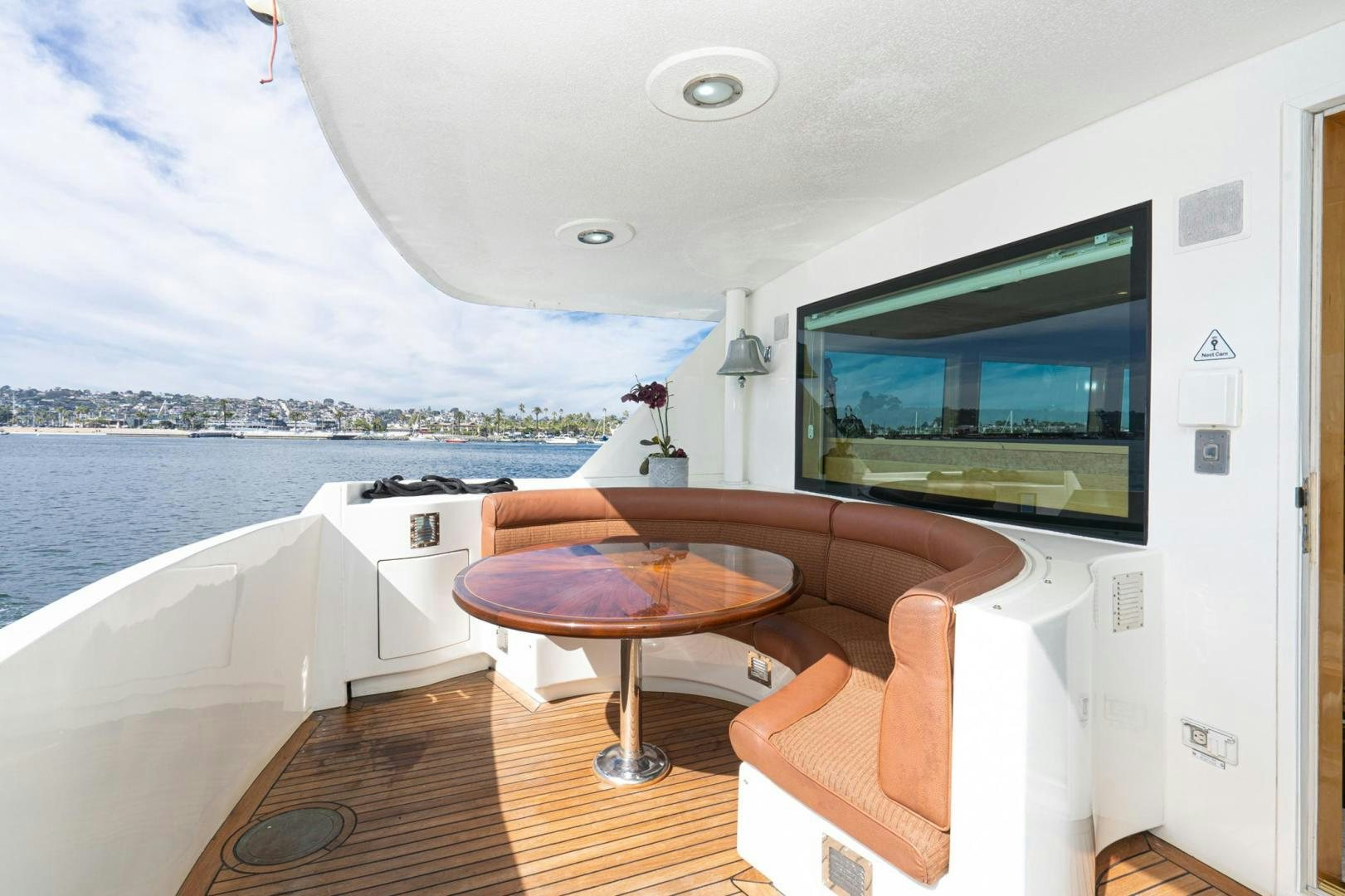 a room with a television and a table and chairs aboard LOVELIEST LADY Yacht for Sale