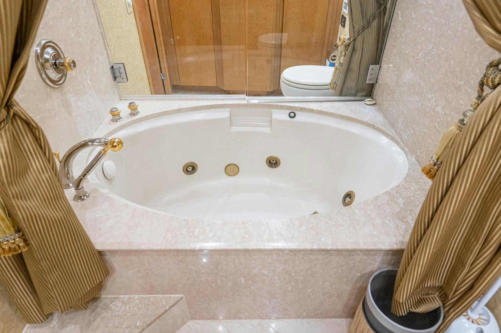 a bathroom with a bathtub and toilet aboard LOVELIEST LADY Yacht for Sale