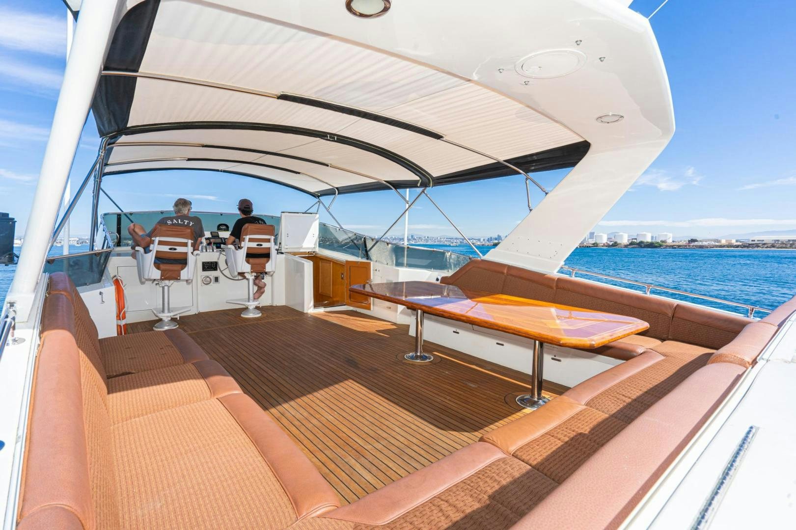 a boat with a couple of people sitting on it aboard LOVELIEST LADY Yacht for Sale