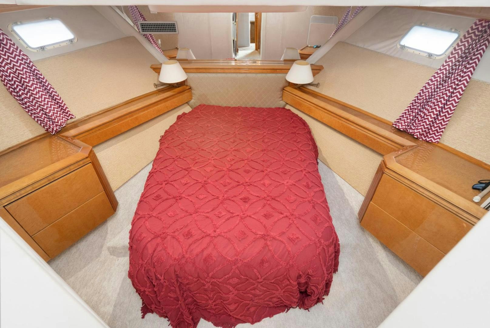 a room with a bed and a lamp aboard LOVELIEST LADY Yacht for Sale