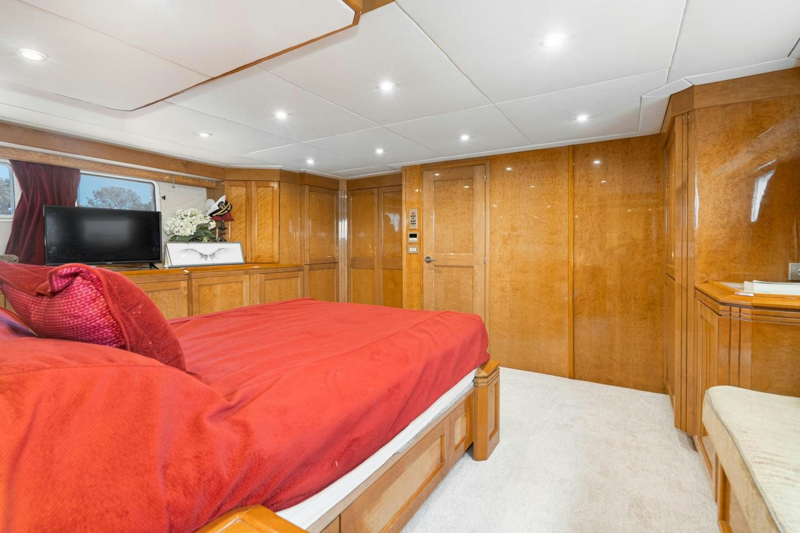 a bedroom with a bed and a tv aboard LOVELIEST LADY Yacht for Sale
