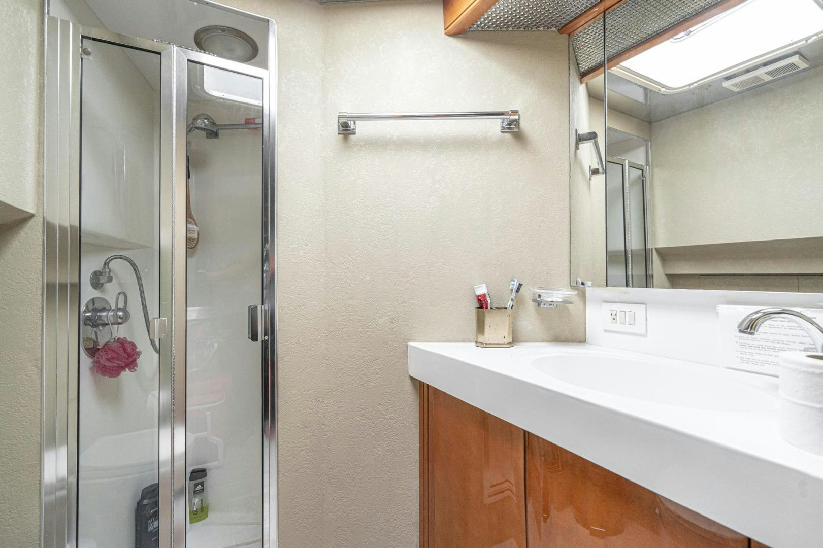 a bathroom with a glass shower aboard LOVELIEST LADY Yacht for Sale