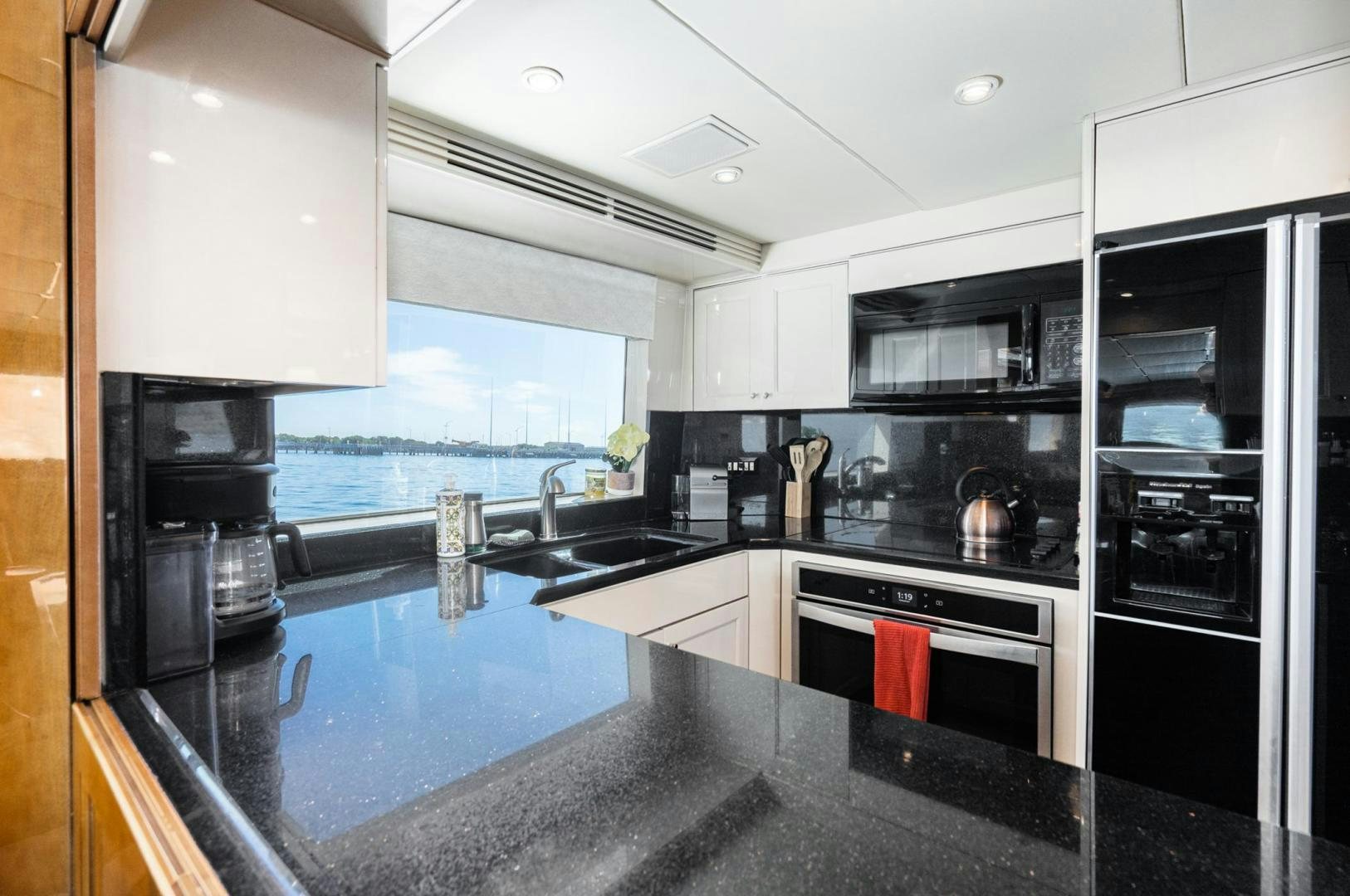a kitchen with black appliances aboard LOVELIEST LADY Yacht for Sale