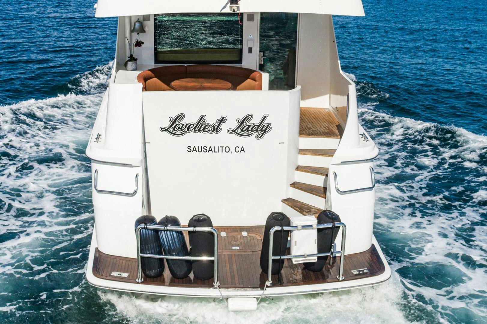 a boat with a steering wheel aboard LOVELIEST LADY Yacht for Sale
