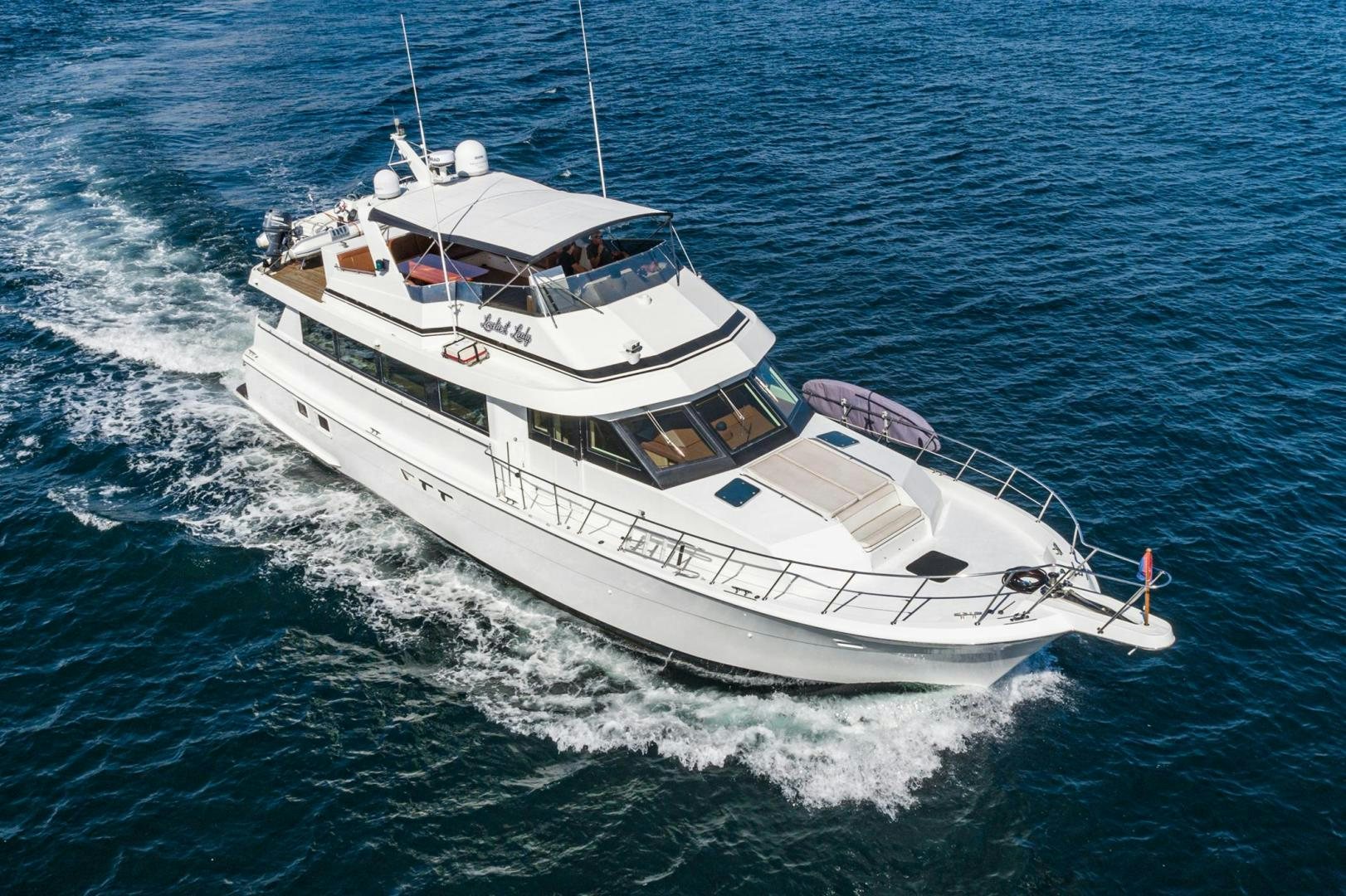 a white boat on the water aboard LOVELIEST LADY Yacht for Sale