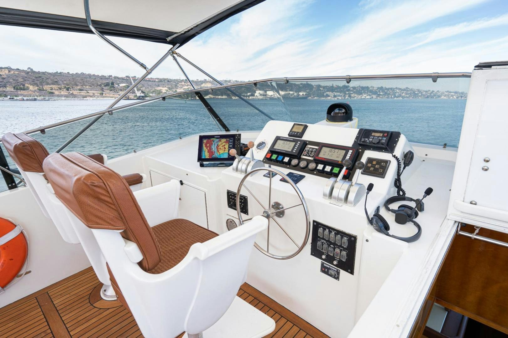 a boat with a view of the ocean and a city below aboard LOVELIEST LADY Yacht for Sale