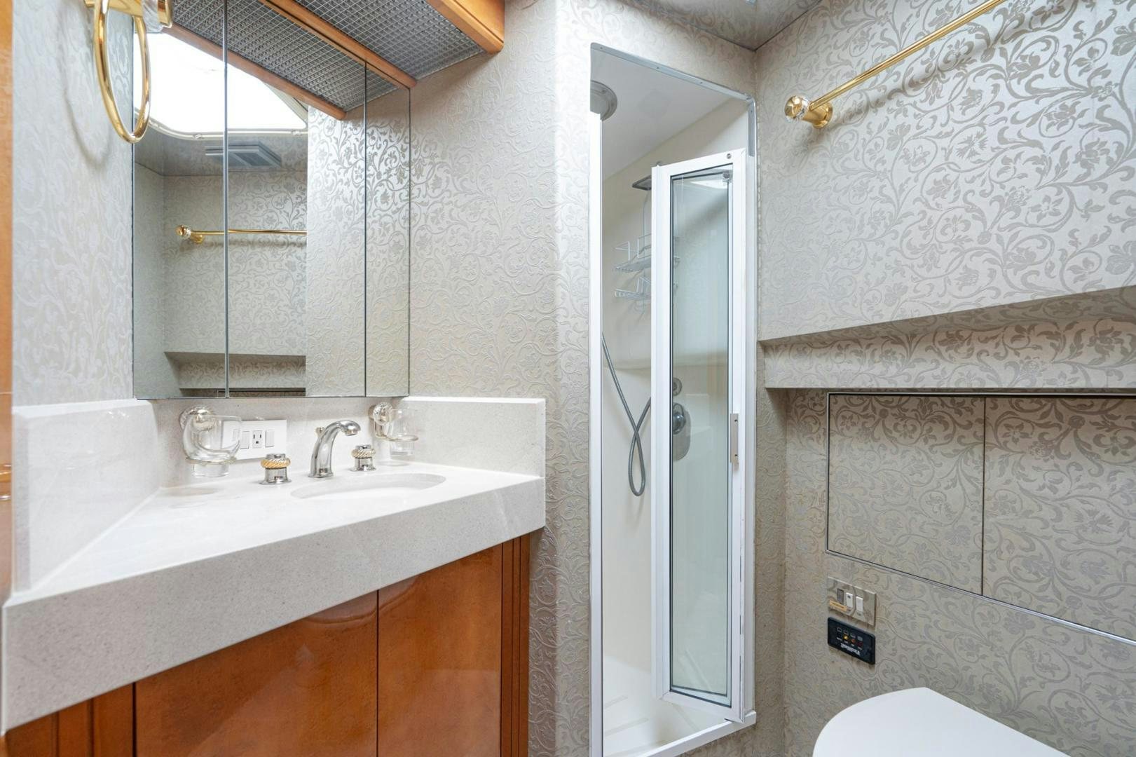 a bathroom with a sink and a mirror aboard LOVELIEST LADY Yacht for Sale