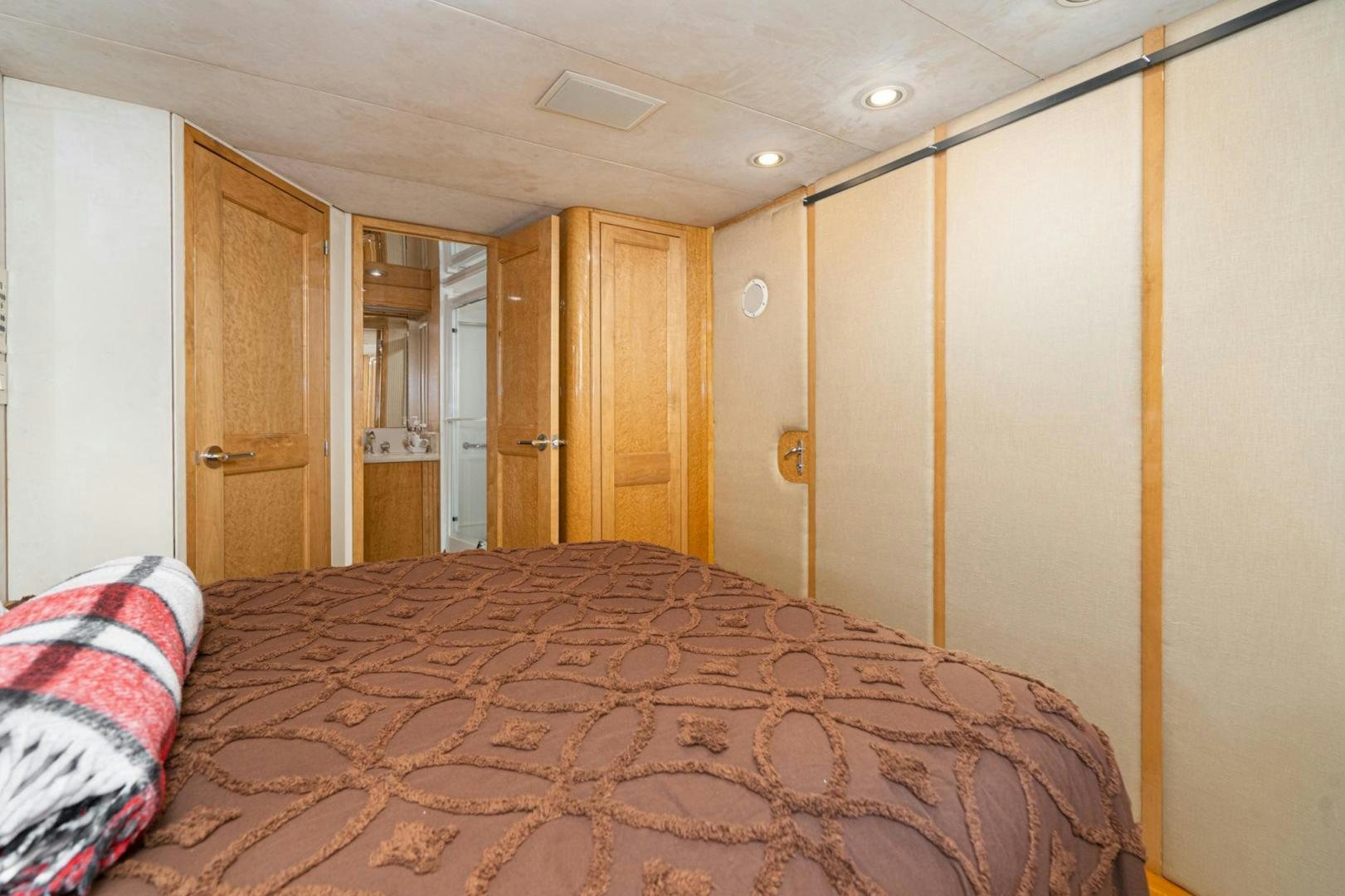 a bedroom with a bed and a closet aboard LOVELIEST LADY Yacht for Sale