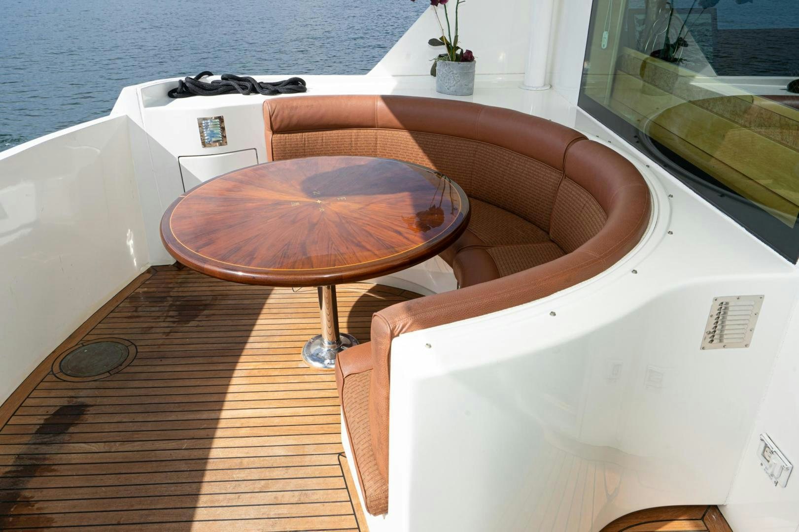 a couple of brown stools on a white surface next to a window aboard LOVELIEST LADY Yacht for Sale
