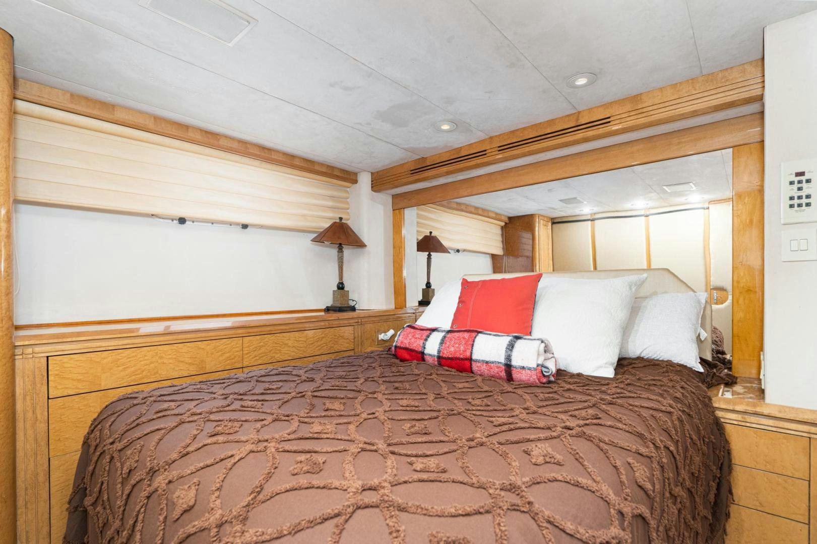a bed with red and white pillows aboard LOVELIEST LADY Yacht for Sale