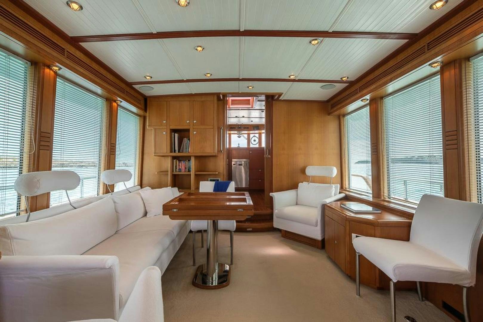 a living room with a table and chairs aboard CAPELLA Yacht for Sale