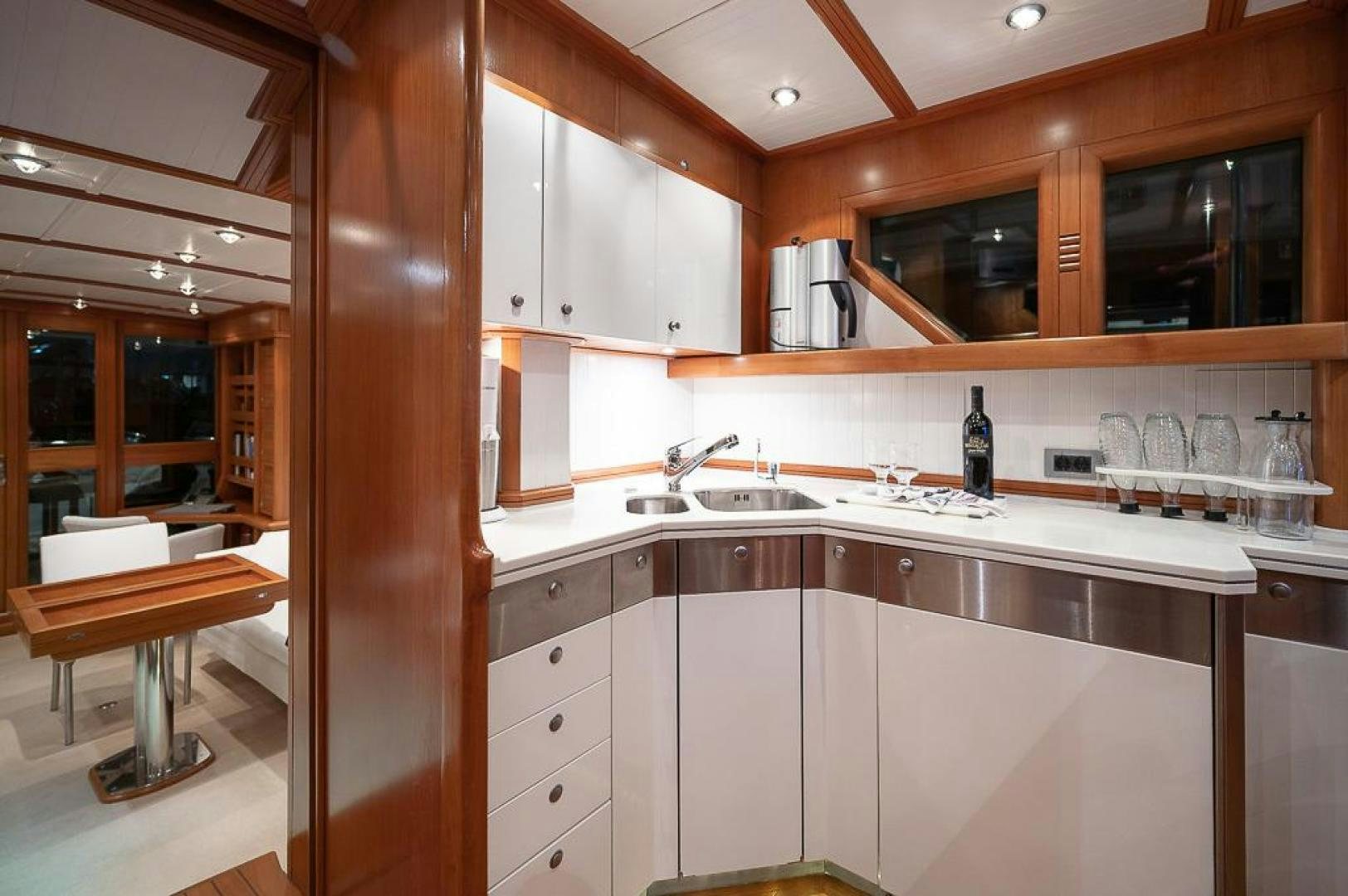 a kitchen with wooden cabinets aboard CAPELLA Yacht for Sale