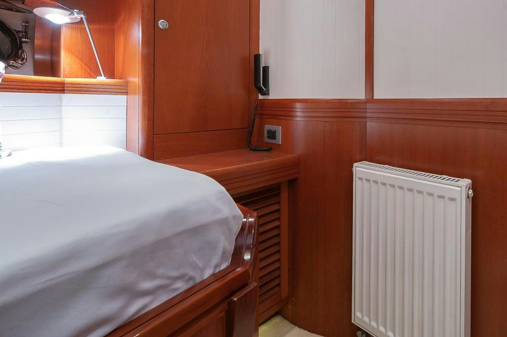 a room with a bed and a closet aboard CAPELLA Yacht for Sale