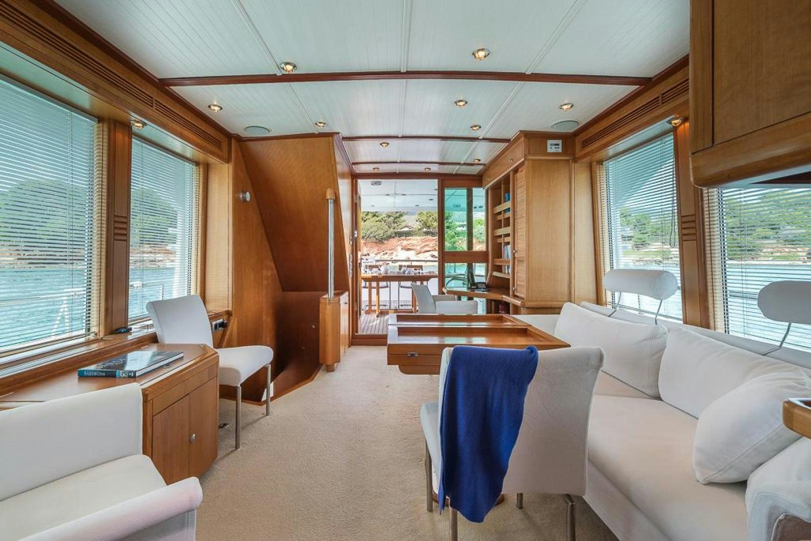 a room with a table chairs and a large window aboard CAPELLA Yacht for Sale