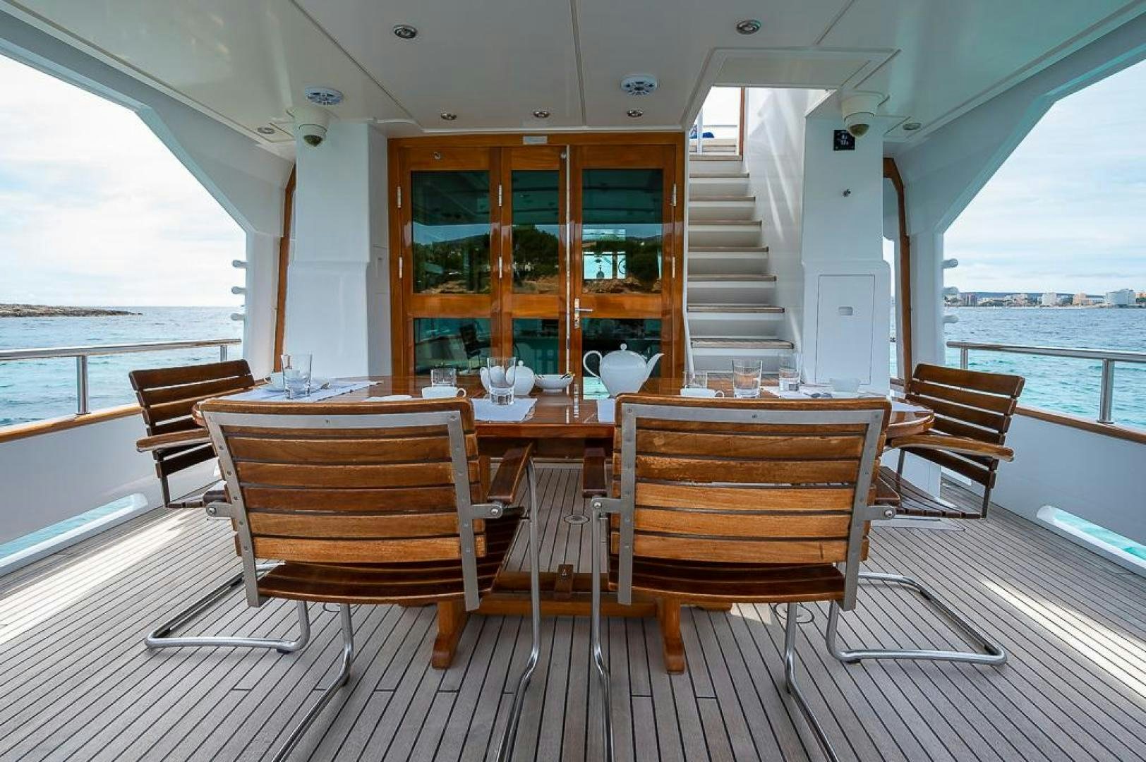 a room with a table and chairs aboard CAPELLA Yacht for Sale