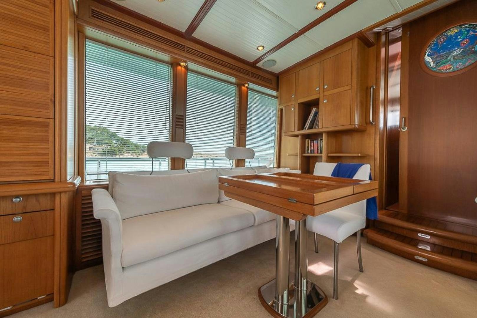 a living room with a couch and a table aboard CAPELLA Yacht for Sale