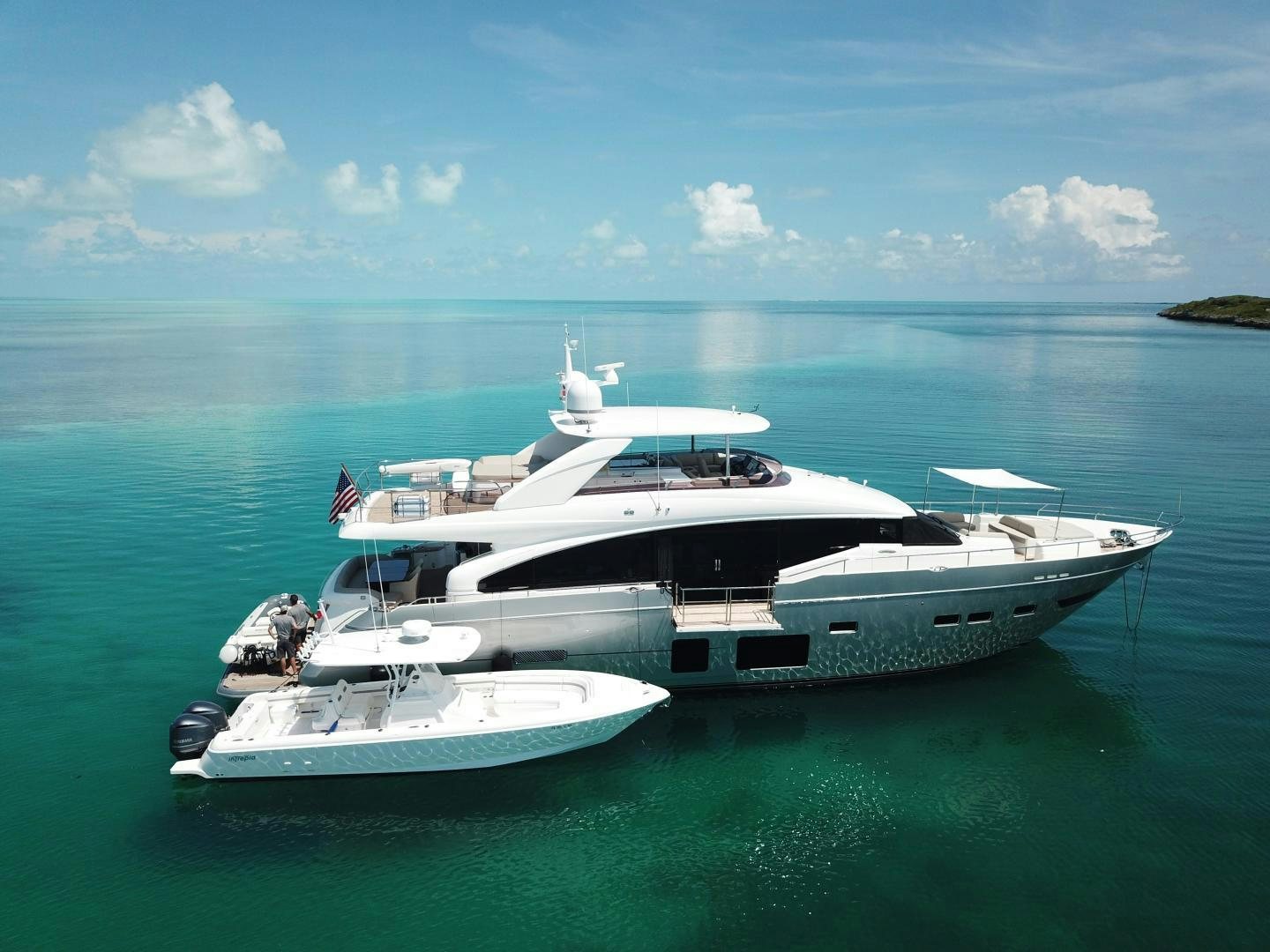 a couple of boats in the water aboard HOT PURSUIT Yacht for Sale