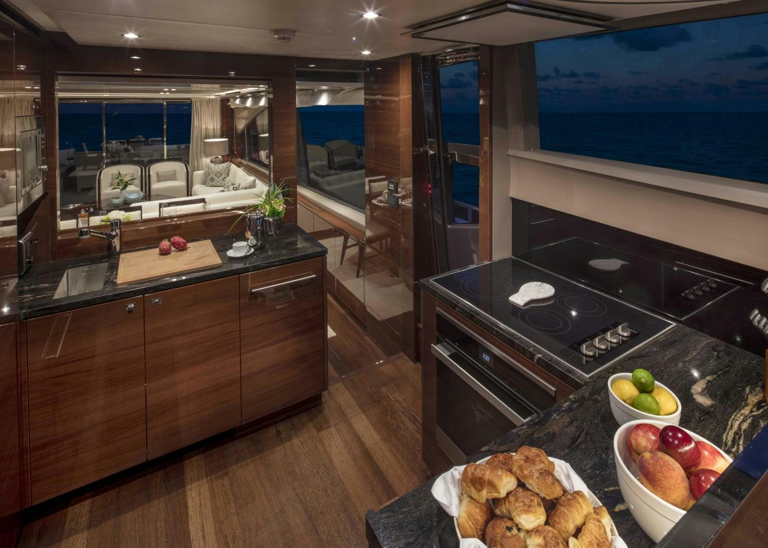 a kitchen with a large window aboard HOT PURSUIT Yacht for Sale