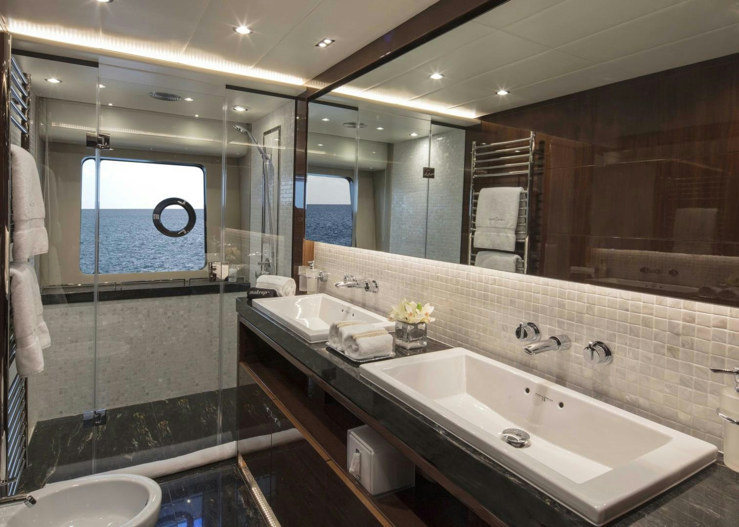 a bathroom with a large mirror aboard HOT PURSUIT Yacht for Sale