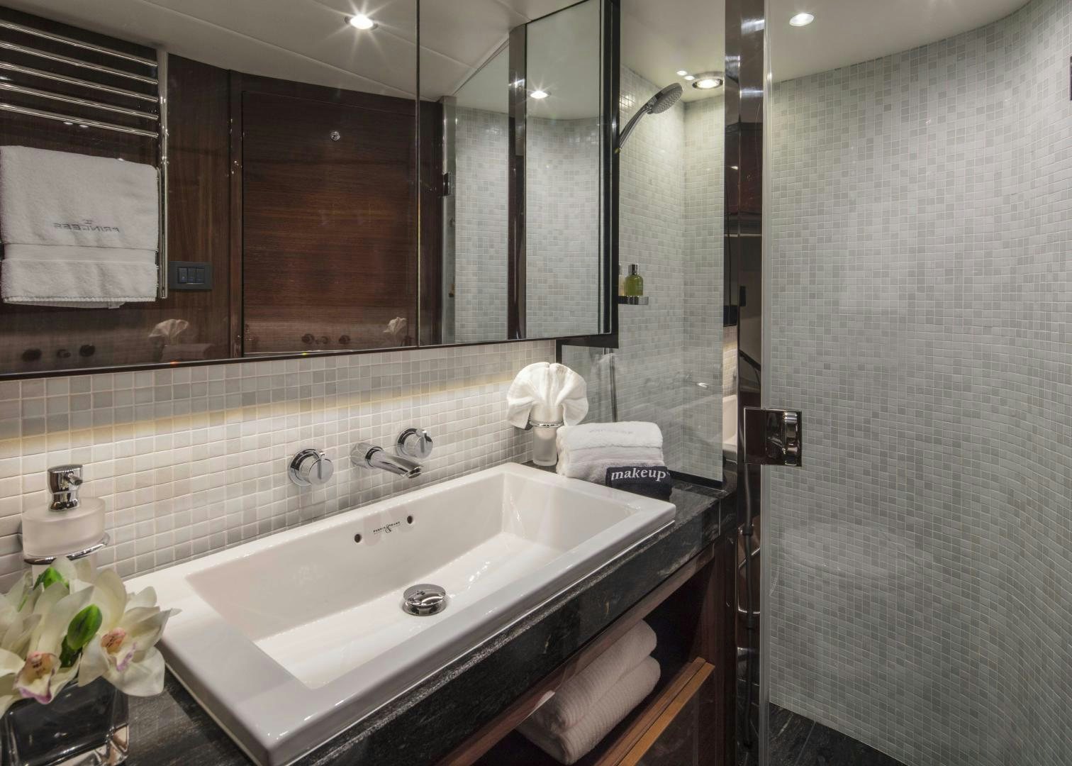 a bathroom with a large mirror aboard HOT PURSUIT Yacht for Sale